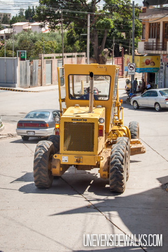 Tractor grader on city streets